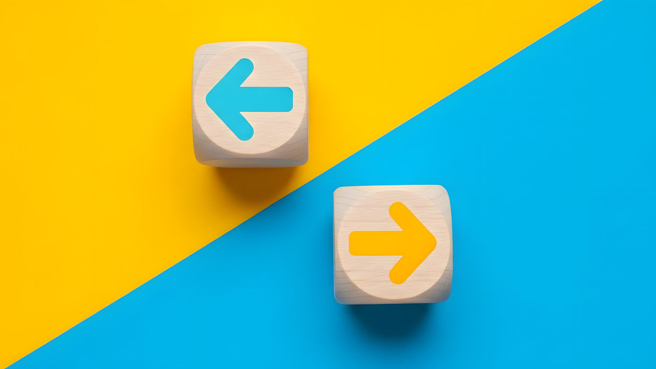 Arrow icons in contrast on wooden cubes moving towards opposite directions. Competition, diversity, opposition or confrontation concept.